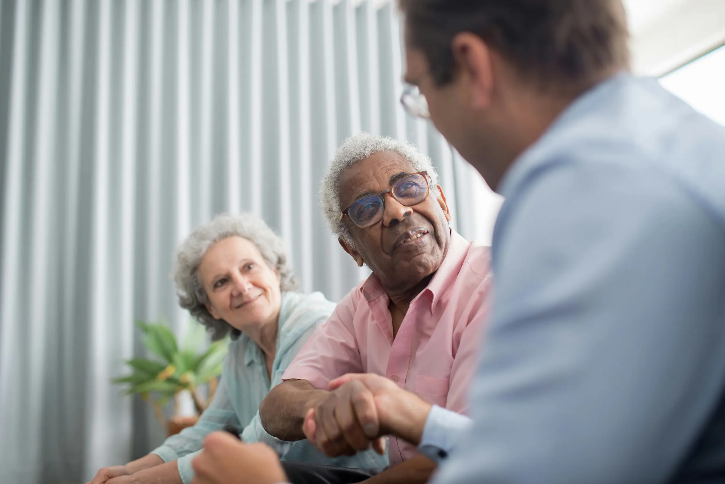 Elderly people shaking hands