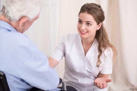 37522115 - nurse talking with elder man staying at residential home